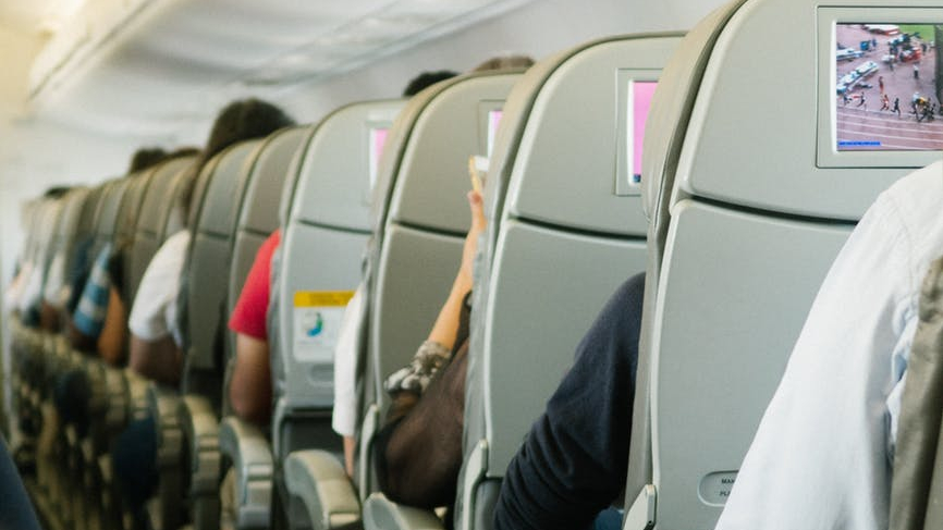 people sitting on plane chairs